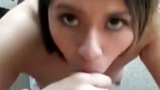 Sexy brunette on her knees swallowing dick