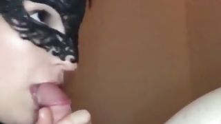 Cute whore in a black mask blowing a huge dick