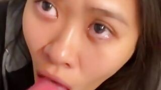 Hot Asian girl on her knees blowing a massive cock